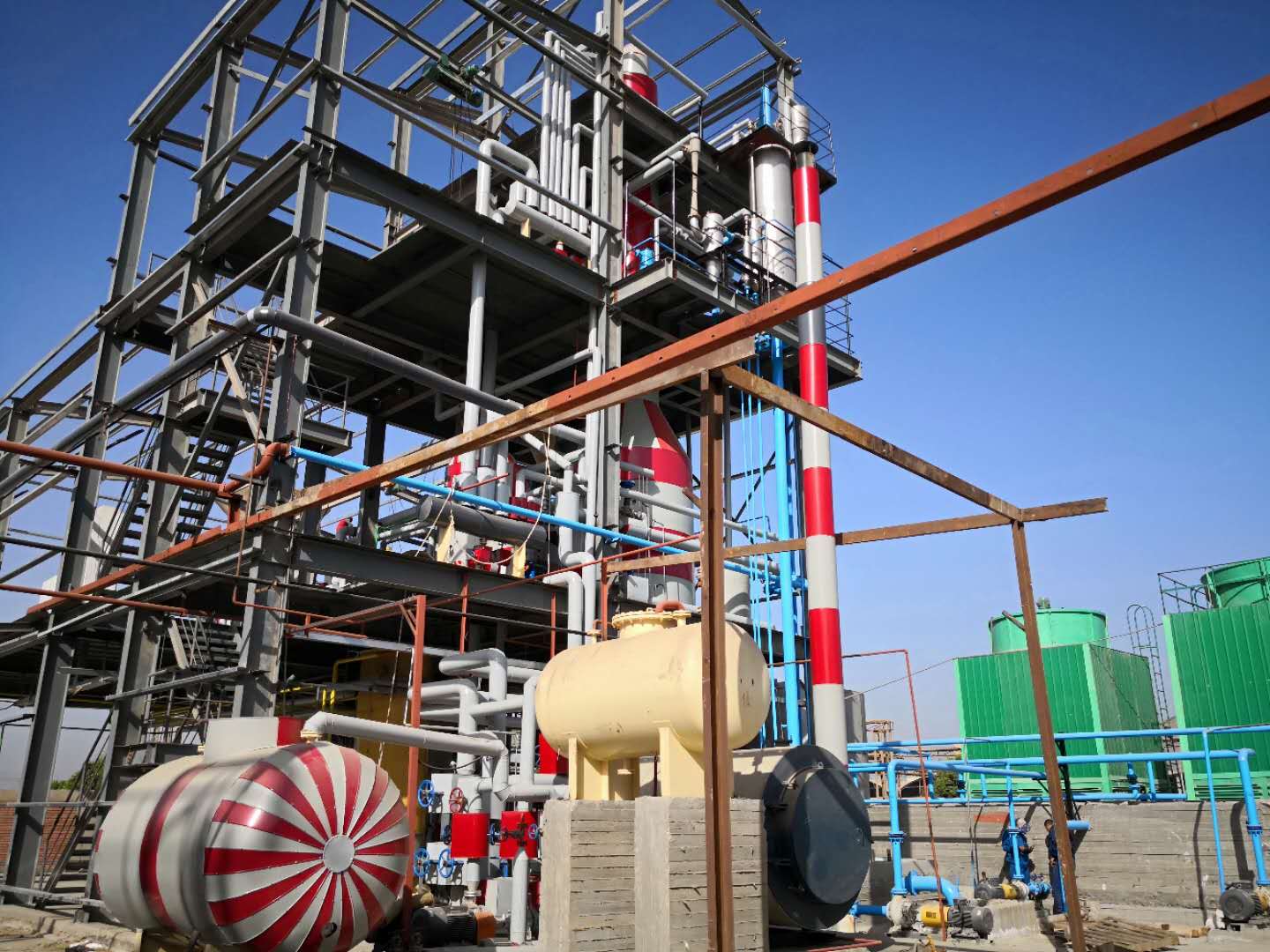 Operator performing routine maintenance check on sunflower seed oil pressing machine to prevent downtime